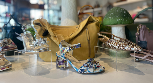 Women’s statement shoes on display with handbags at Waterlily Shoes in Sidney by the Sea.