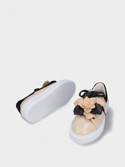 Pair of sneakers with floral design on a light gray background