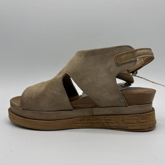 Brown sandal with platform sole on a white background