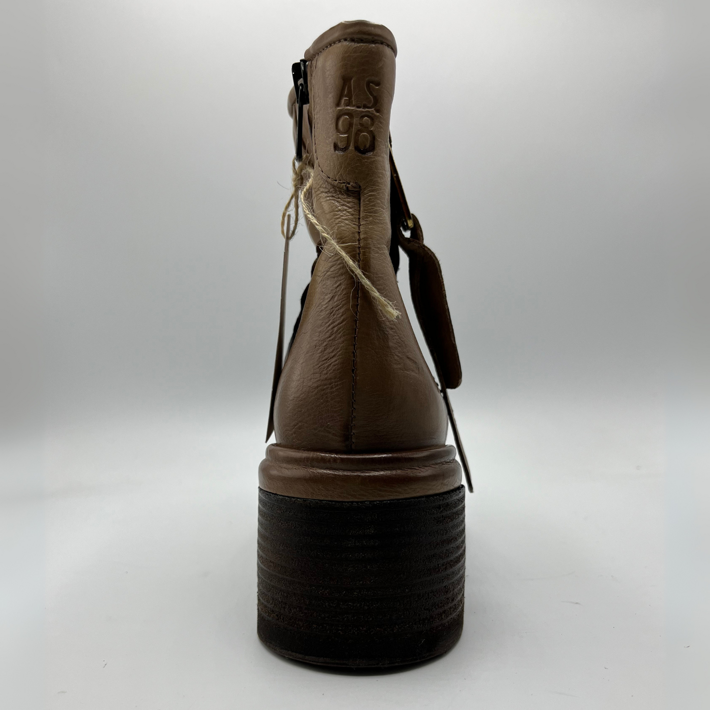 Brown boot with black sole on a white background