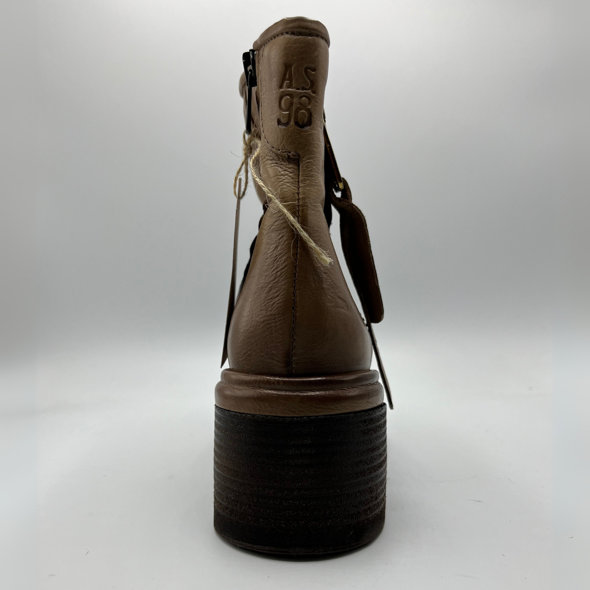 Brown boot with black sole on a white background