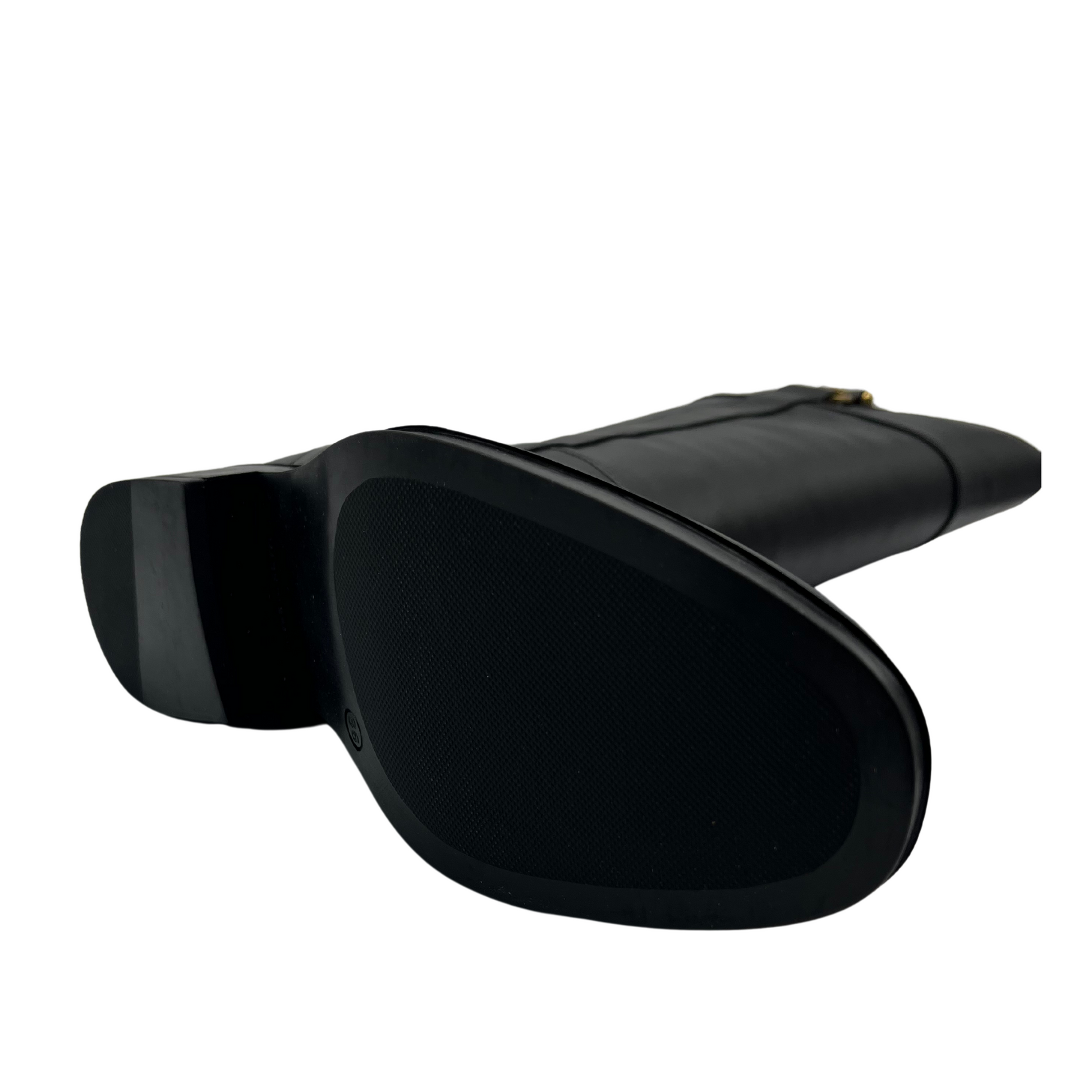 Bottom view of black leather riding boot with short block heel, rounded toe and gold bit detail