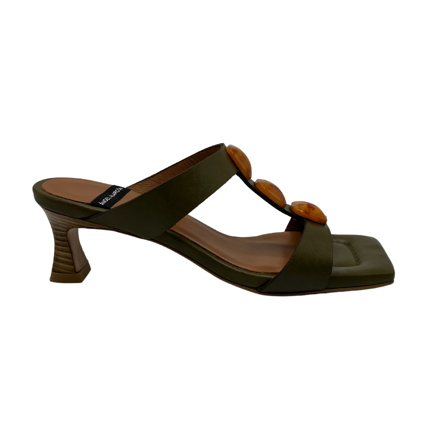 Right facing view of khaki leather sandal with square toe and square ornaments on upper. Flared heel and padded insole.