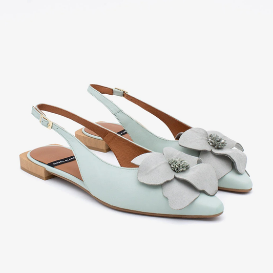 Light blue slingback shoes with floral details on a white background