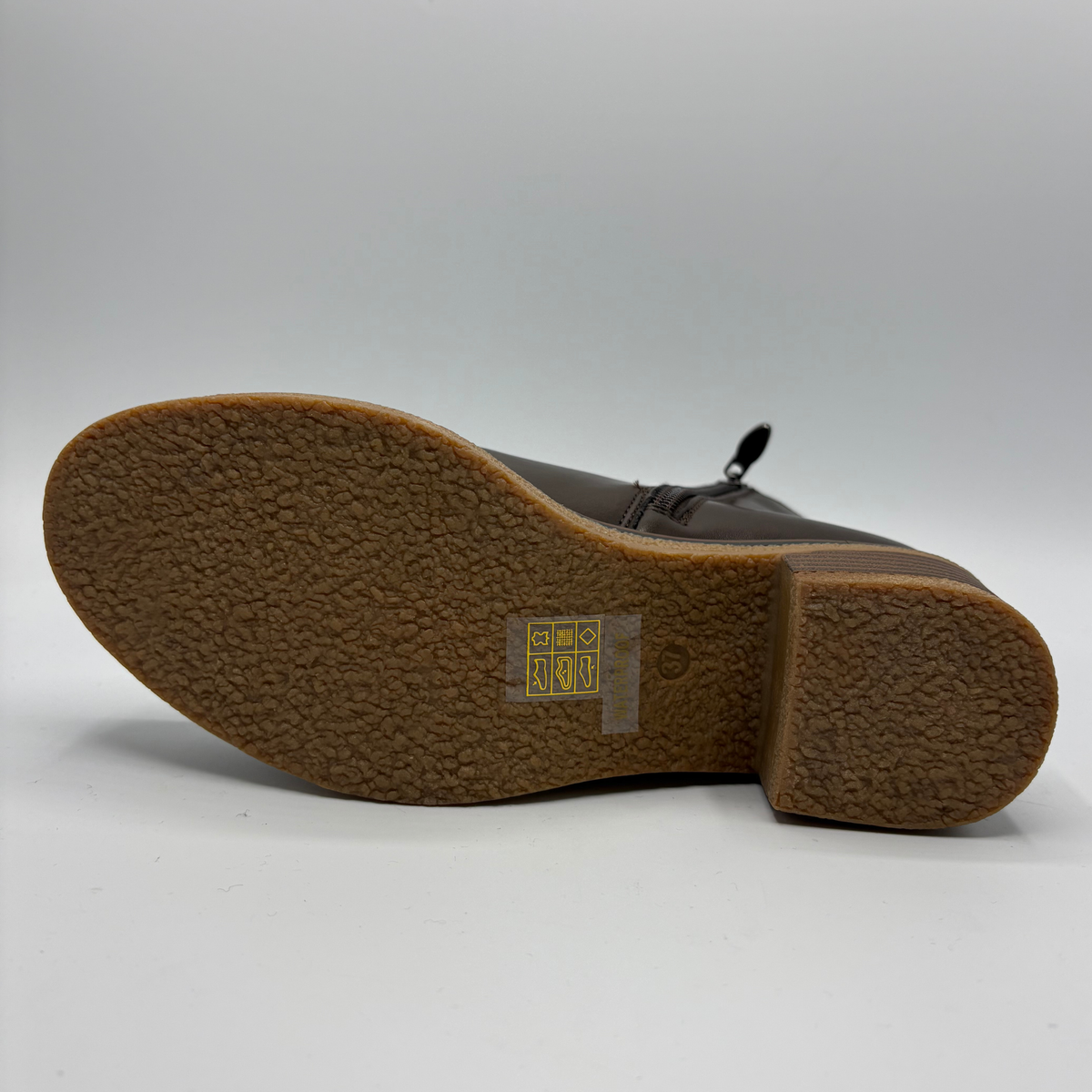 Bottom view of a brown chelsea boot with a pull on heel tab