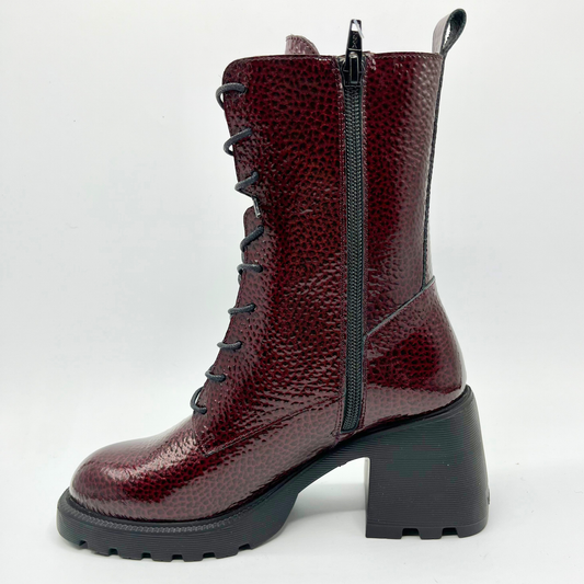 Burgundy leather boot with a black zipper on a white background