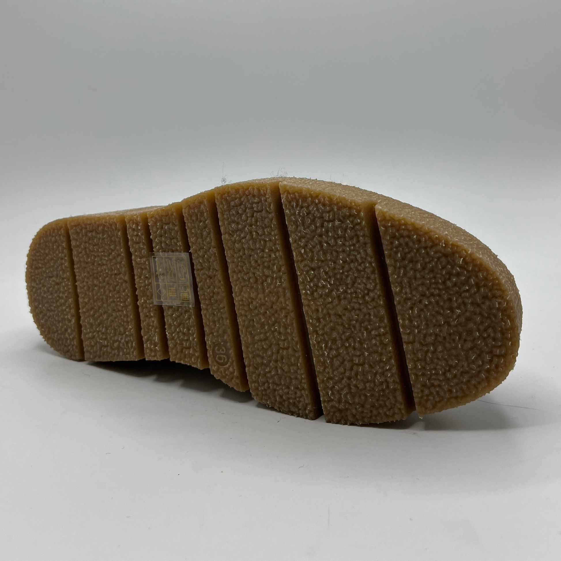 Close-up of a brown shoe sole on a white background