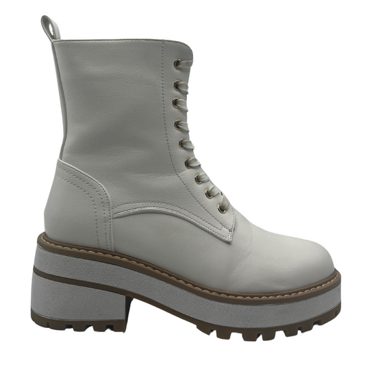 Right facing view of white vegan leather boot with chunky sole and lace up front