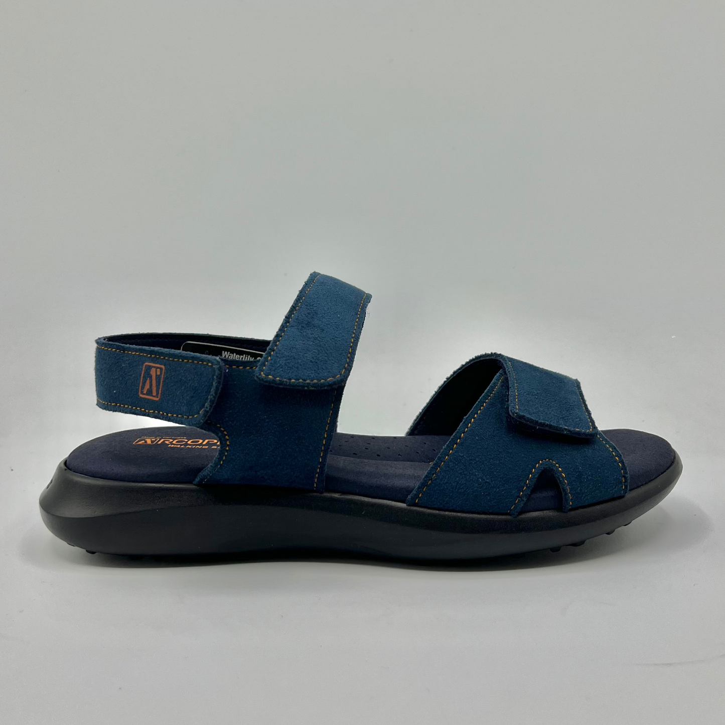 Right facing view of a blue multi-strap sandal with hook and loop closures and a black supportive outsole.