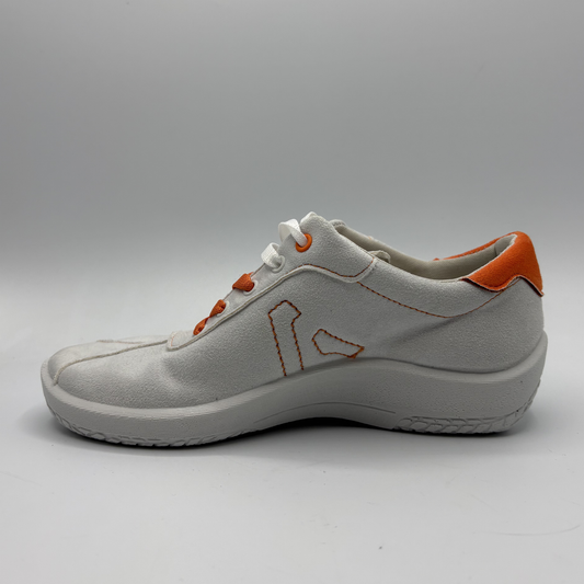White sneaker with orange accents on a gray background