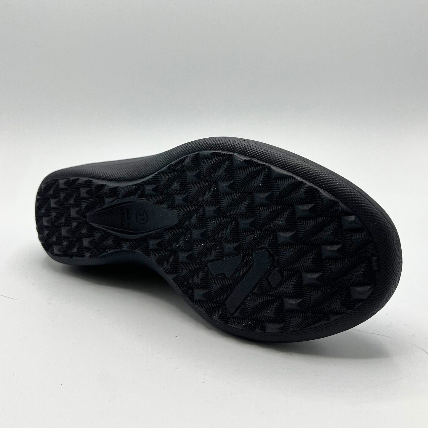 Black rubber sole of a shoe on a white background