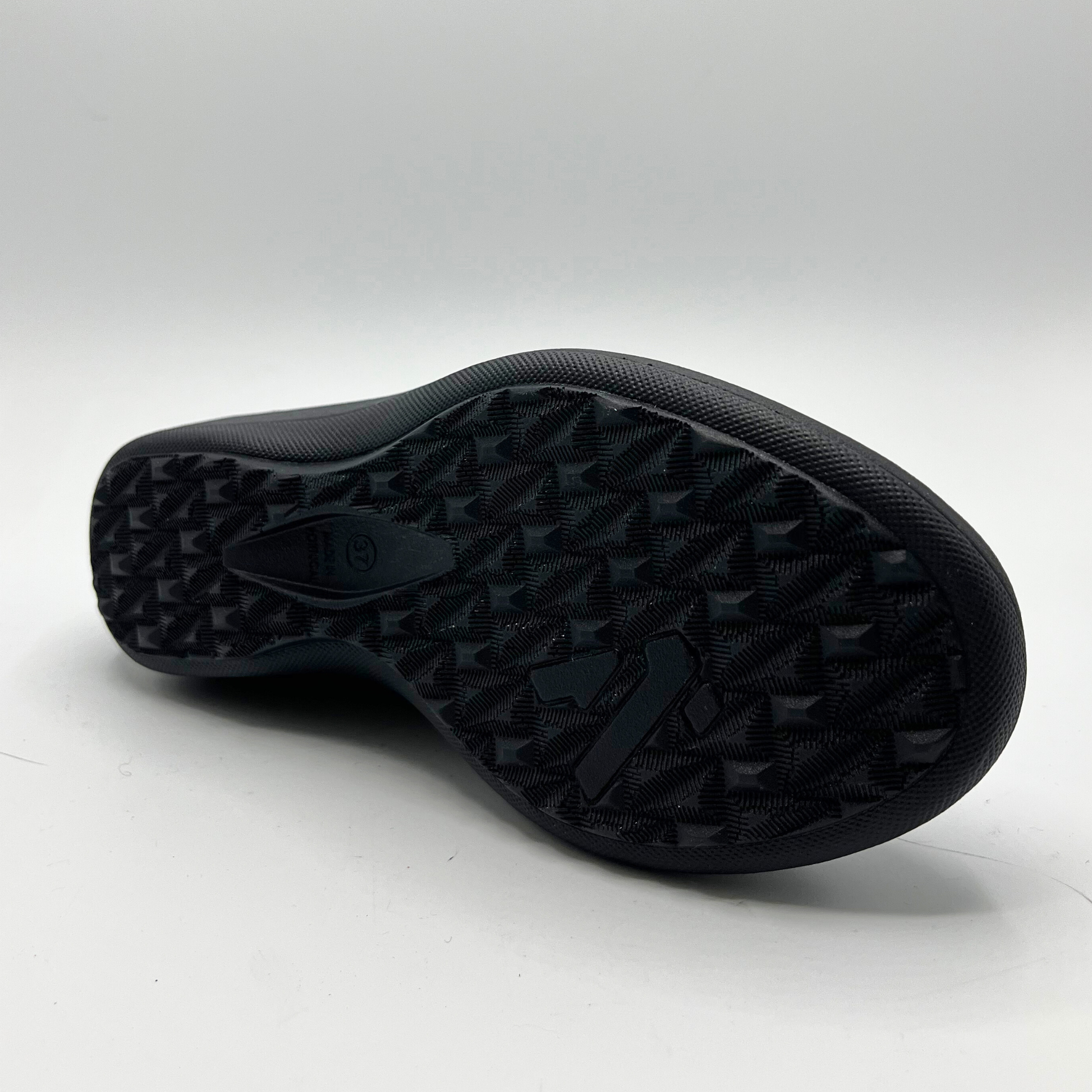 Black rubber sole of a shoe on a white background