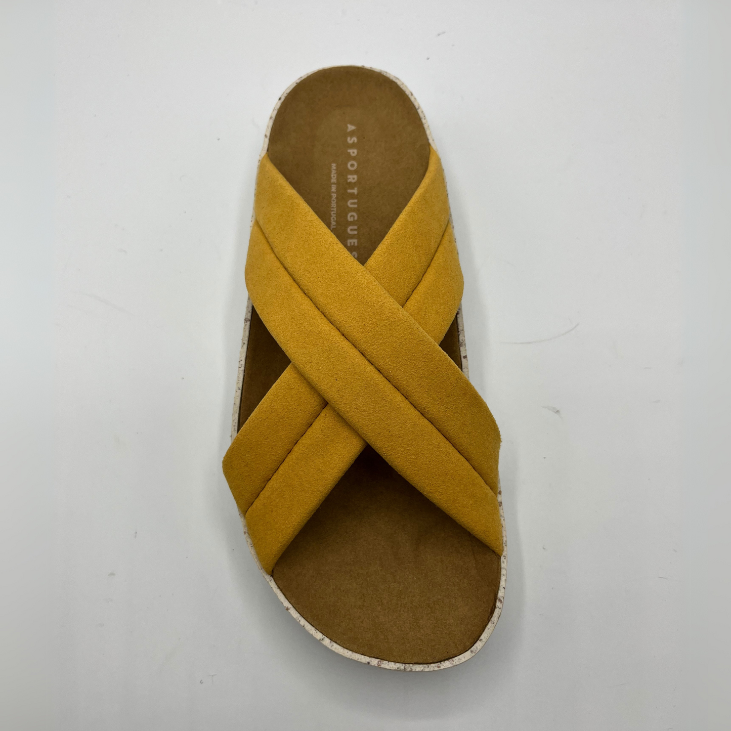 Top view of cushioned, cross strap sandal with a contoured footbed and white speckled outsole.