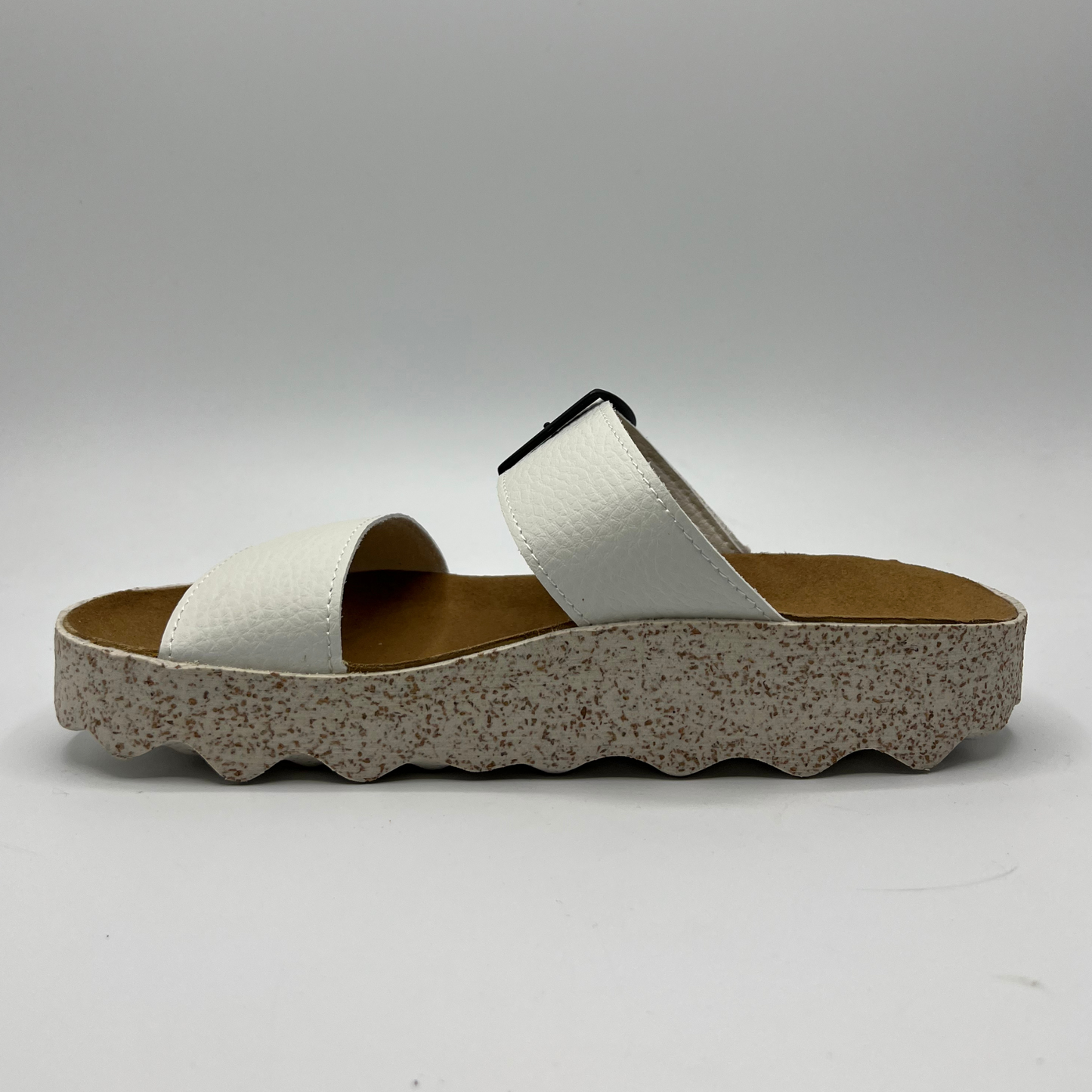 Left facing view of double strap white faux leather sandal with a contoured footbed and thick white and brown speckled outsole.
