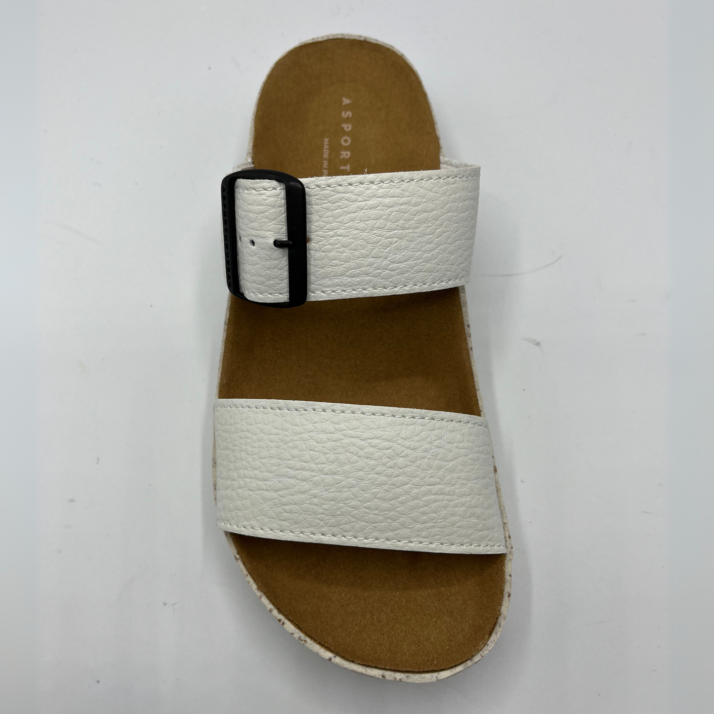 Top view of double strap white faux leather sandal with a contoured footbed and thick white and brown speckled outsole.
