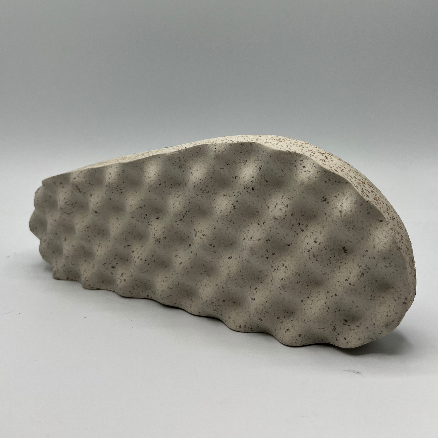 Bottom view of a green textile slip on clog with a contoured footbed and lightweight outsole.