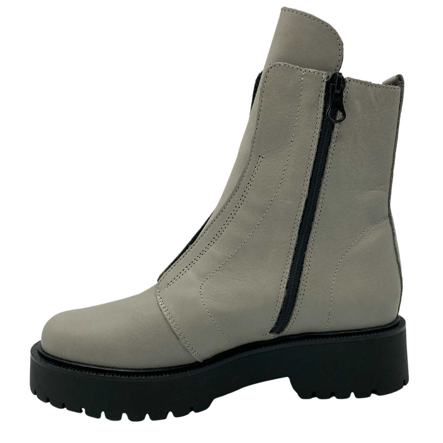 Left facing view of cement coloured leather short boot with black side zipper and lug sole