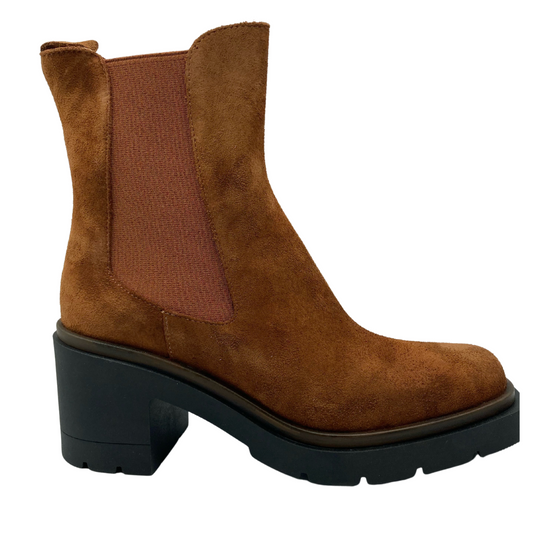 Right facing view of tan suede short boot with elastic side gore and black rubber sole and heel