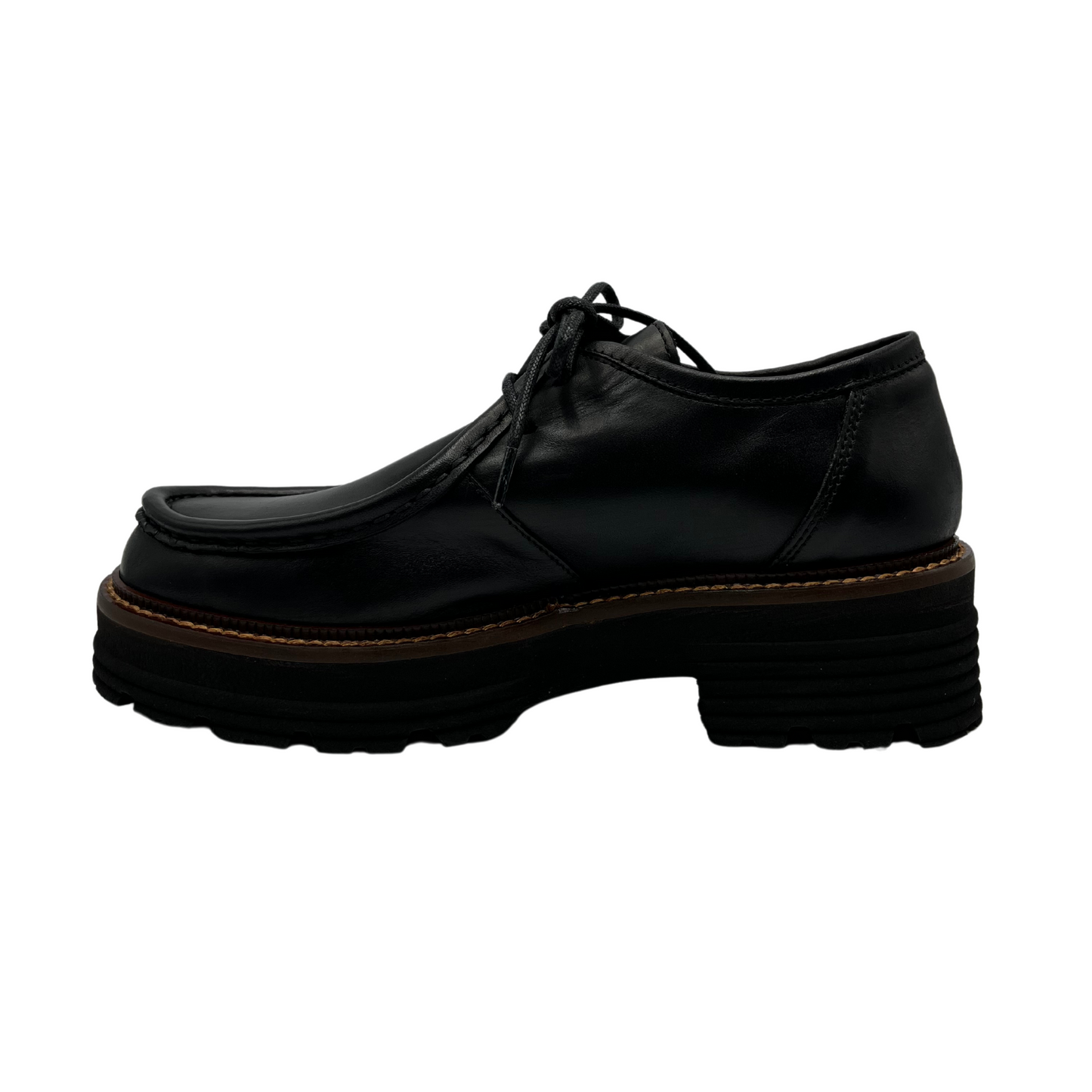 Left facing view of black leather loafer with thick black outsole and leather lining