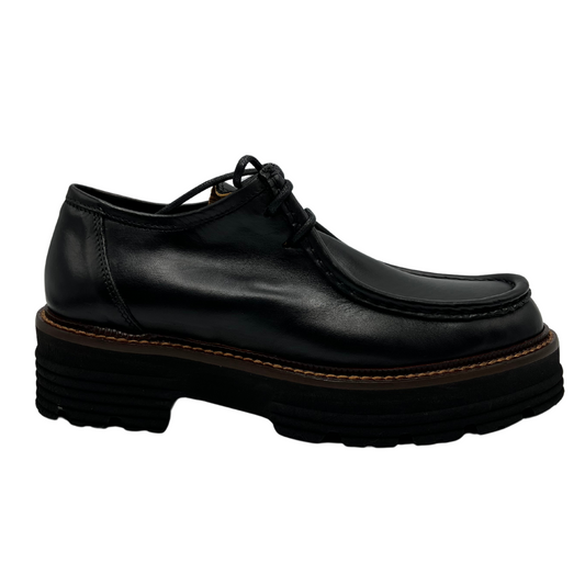 Right facing view of black leather loafer with thick black outsole and leather lining