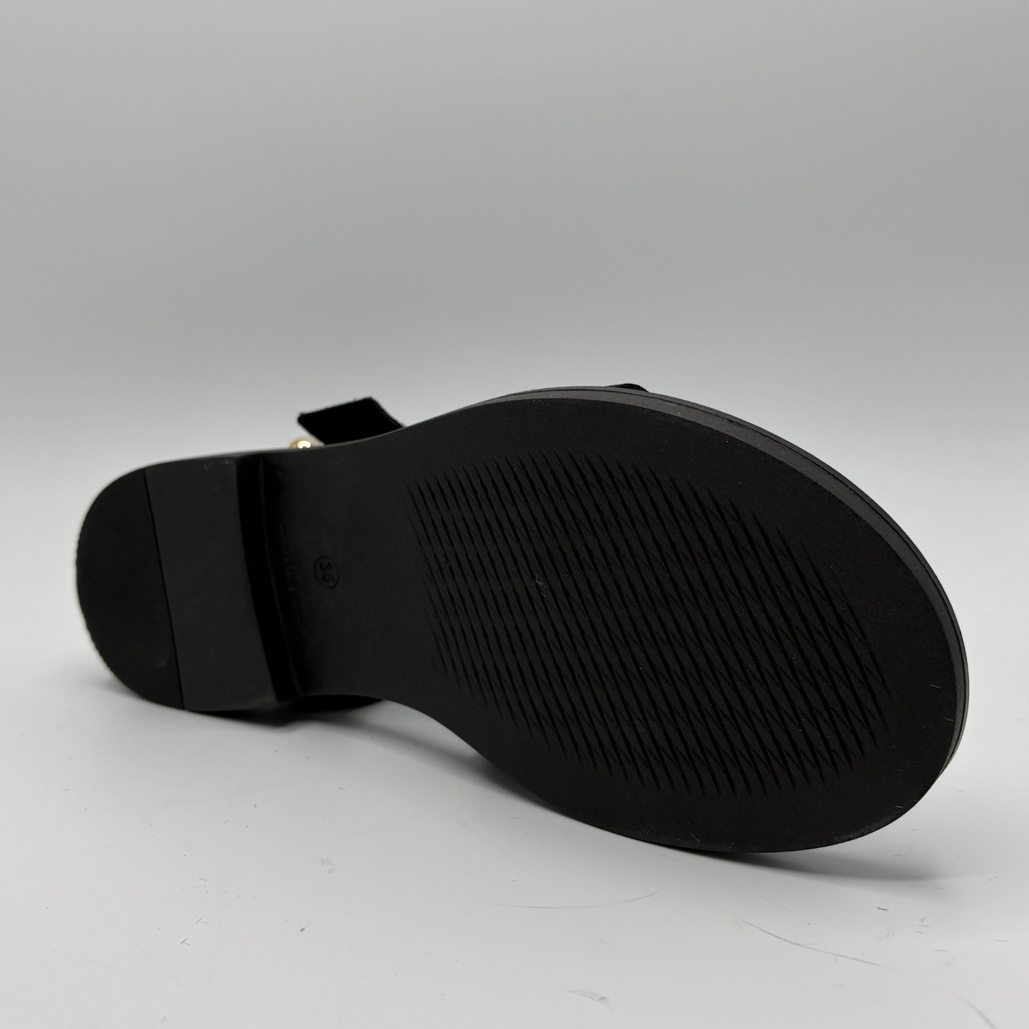 Black sandal sole on a gray background