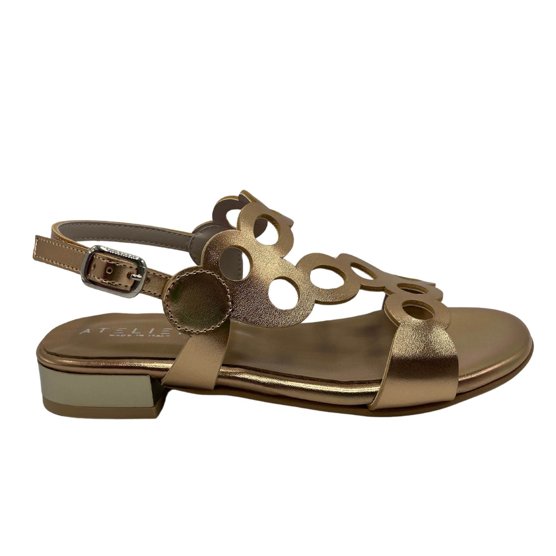 Right facing view of cut out leather sandal in metallic gold with a delicate ankle buckle strap and short block heel