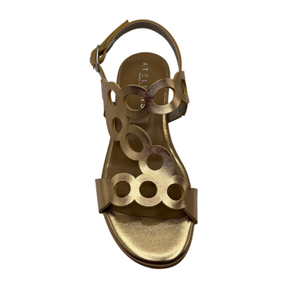 Top view of cut out leather sandal in metallic gold with a delicate ankle buckle strap and short block heel