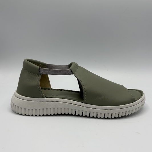 Green sandal with a white sole on a gray background