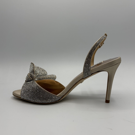 High-heeled sandal with decorative bow and embellishments on a gray background