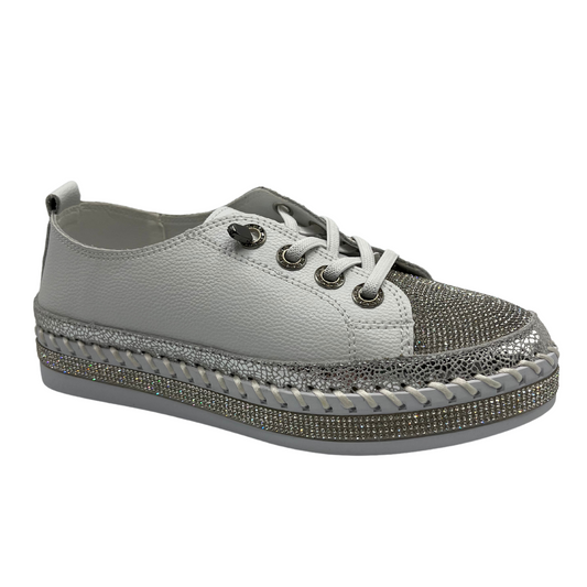 45 degree angled view of white platform sneaker with bejewelled accents on upper, toe and around the platform sole 