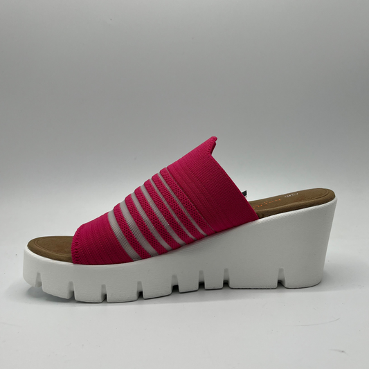 Left facing view of a fuschia elastic slip on sandal with a white wedge heel.
