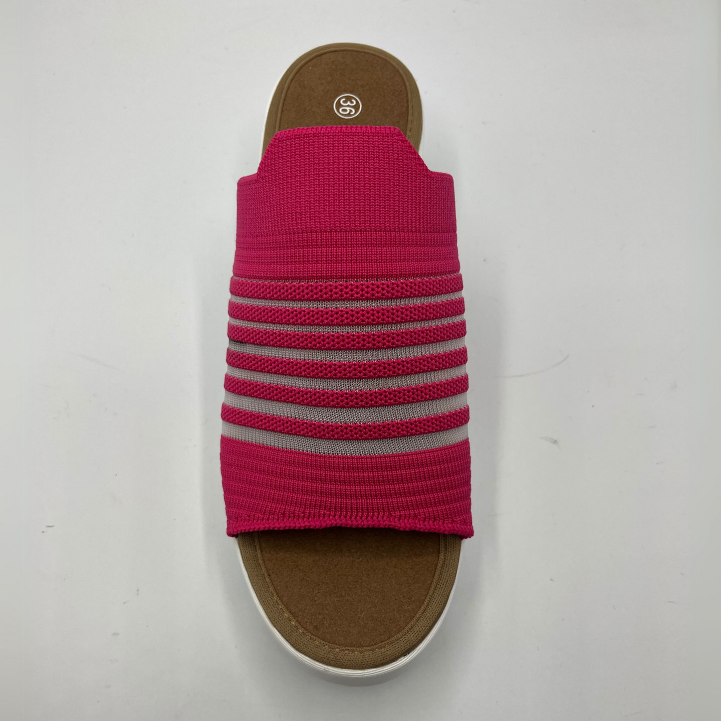 Top view of a fuschia elastic slip on sandal with a white wedge heel.
