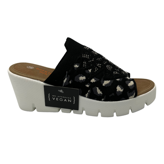 Right facing view of a slip on wedge heel. White rubber outsole and stretchy knit upper.