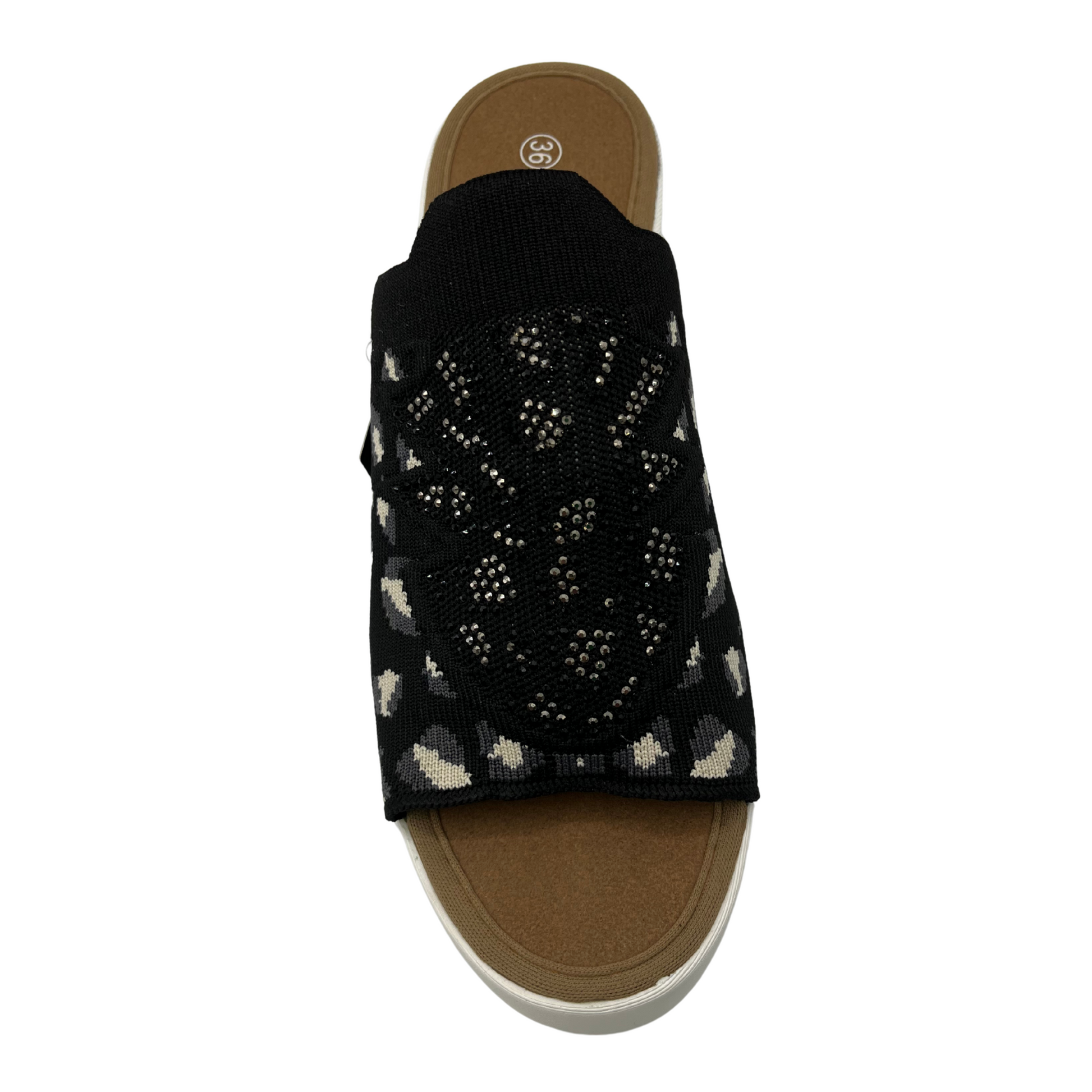 Top facing view of a slip on wedge heel. White rubber outsole and stretchy knit upper.