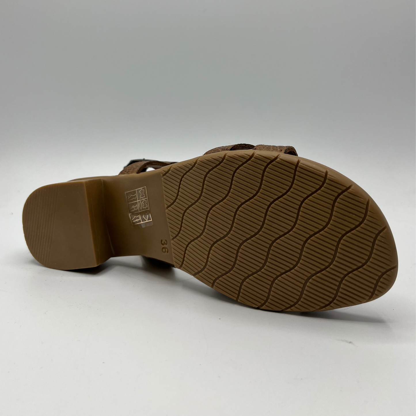 Bottom view of a textured leather sandal with a wood look short heel and an adjustable slingback strap