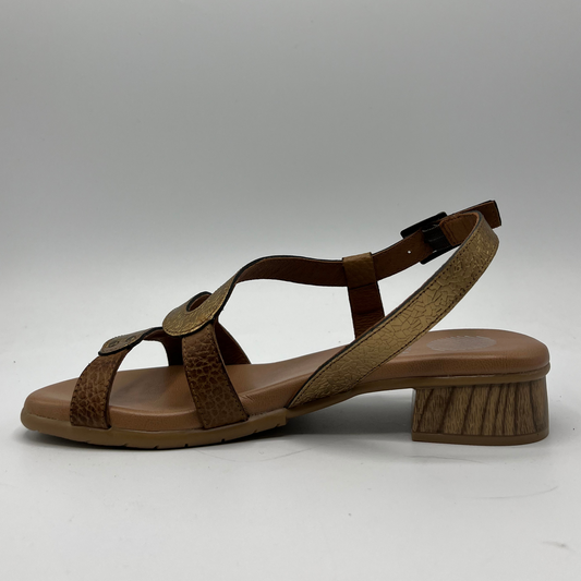Left facing view of a textured leather sandal with a wood look short heel and an adjustable slingback strap