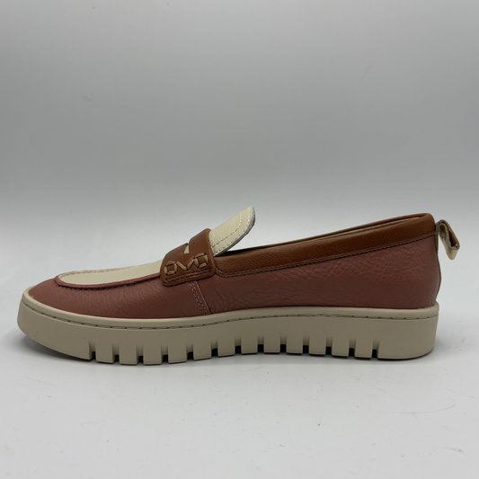 Left facing view of a brown and beige slip on loafer