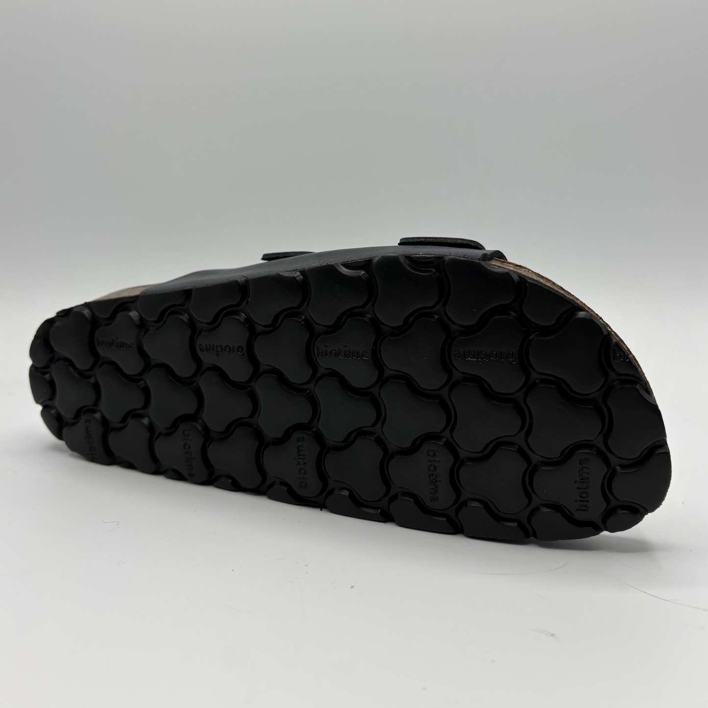 Black sandal sole on a gray background