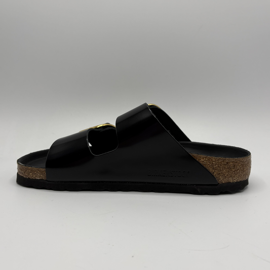 Black sandal with a cork sole on a gray background