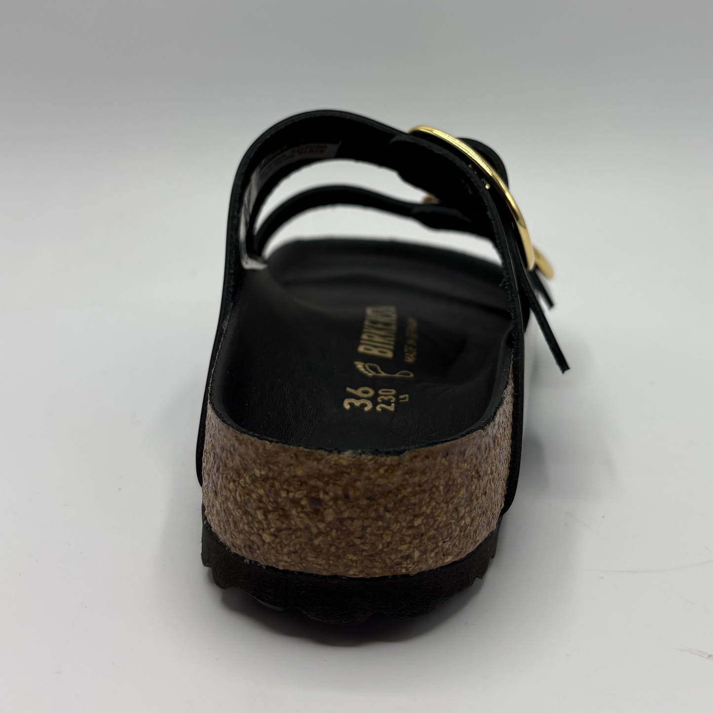 Black sandal with cork sole on a white background