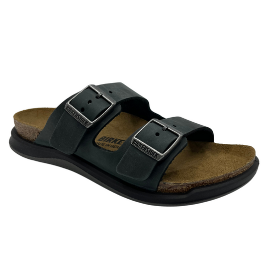 45 degree angled view of leather strapped sandals with contoured cork footbed