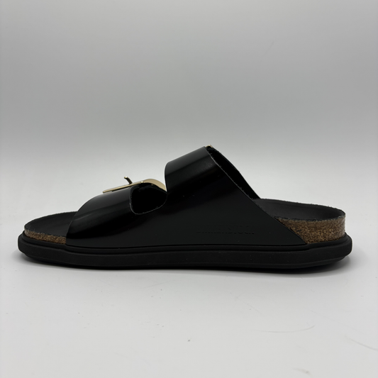Black sandal with a cork sole on a gray background