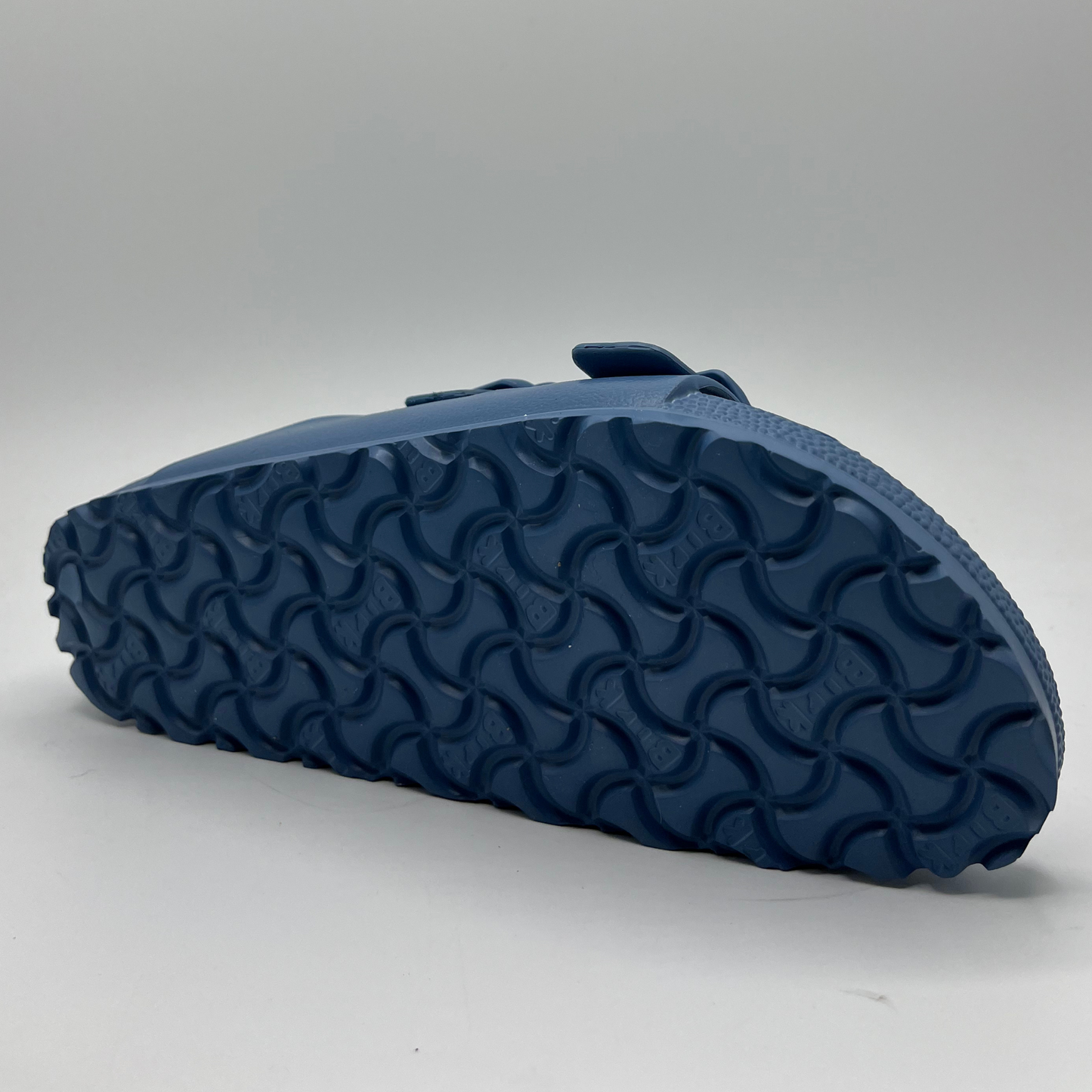 Bottom view of a lightweight EVA sandal in a blue colour with two adjustable straps.