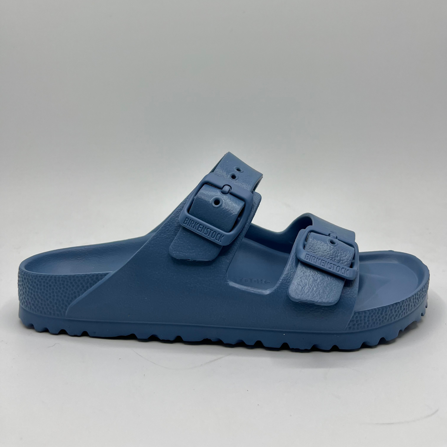 Right facing view of a lightweight EVA sandal in a blue colour with two adjustable straps.