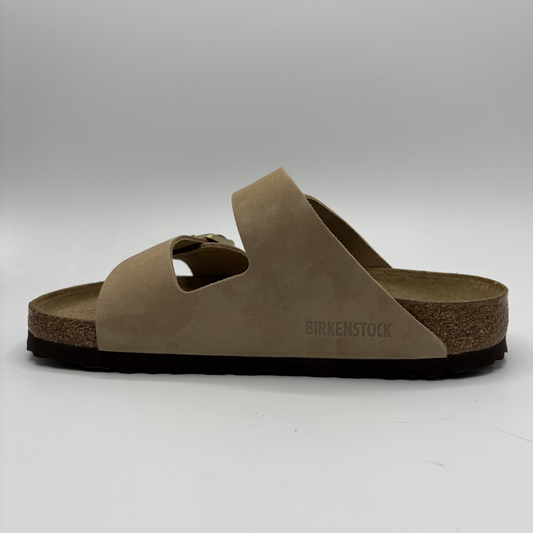Brown sandal with 'Birkenstock' branding on a white background