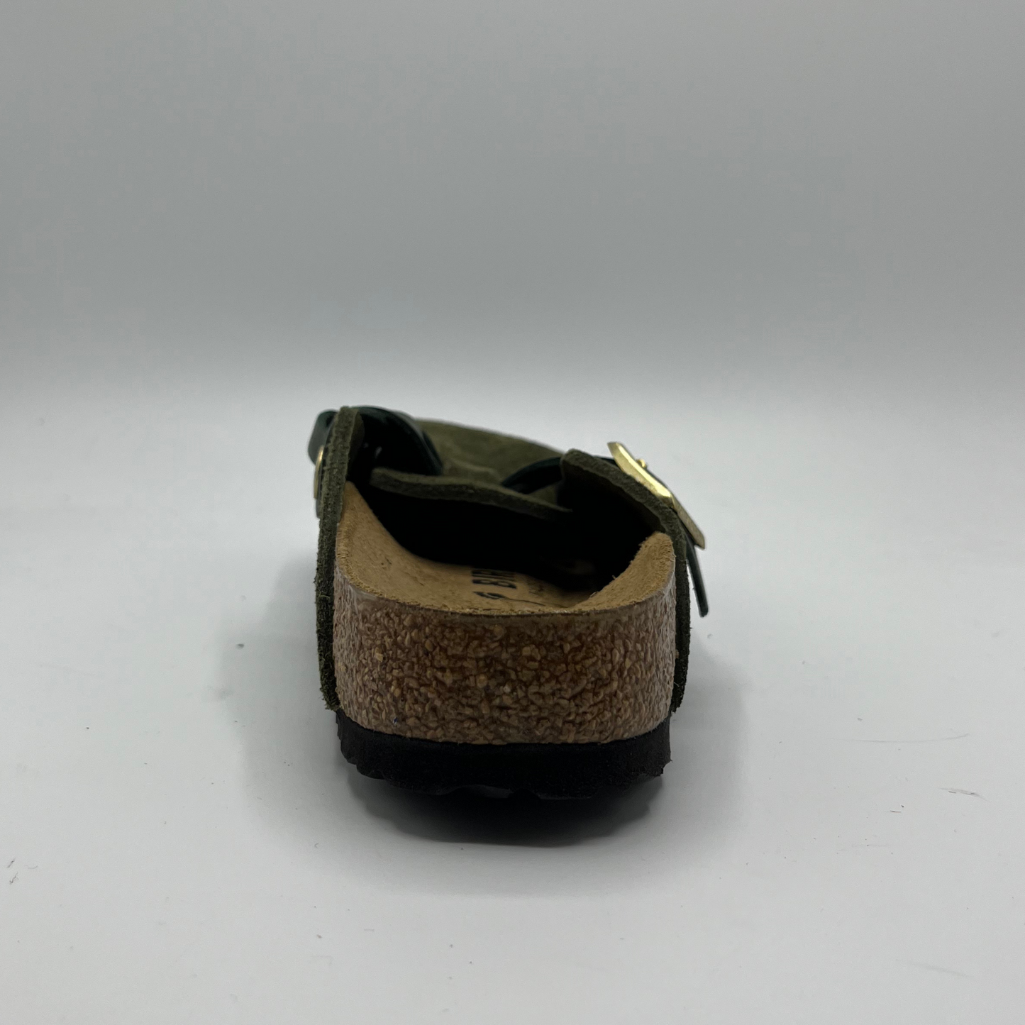 Green sandal with cork sole on a gray background