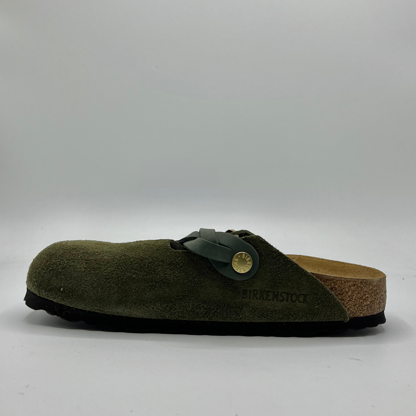 Green clog sandal with cork sole on a white background