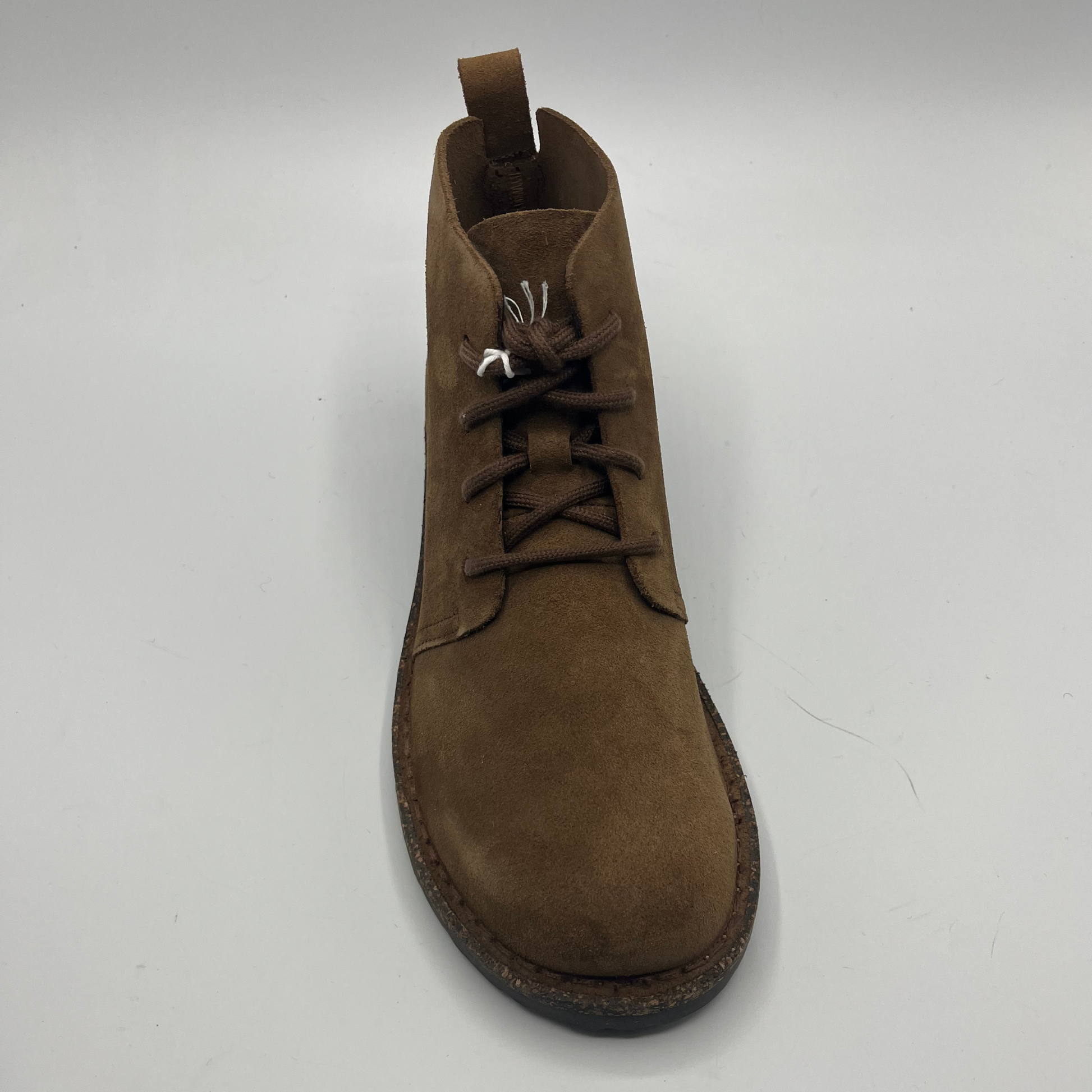 Brown suede boot on a white background