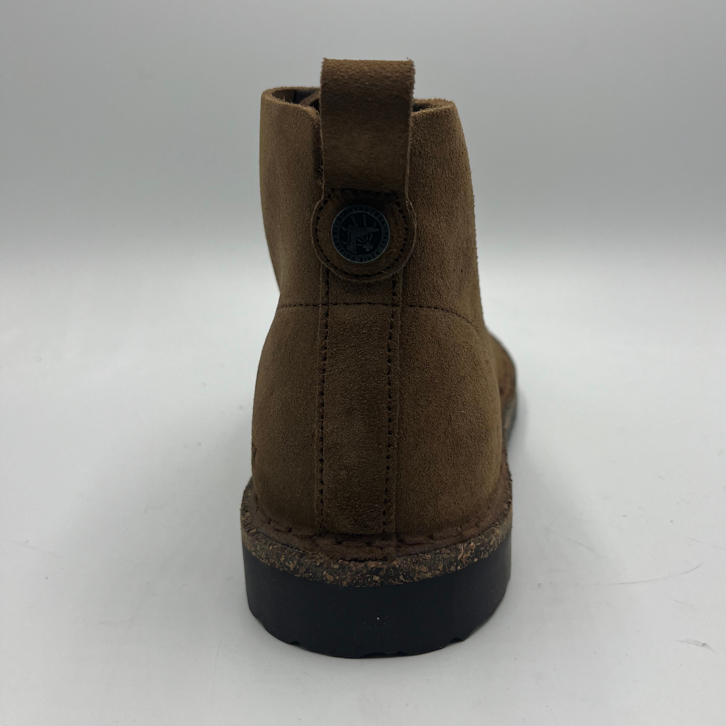 Brown suede boot on a white background