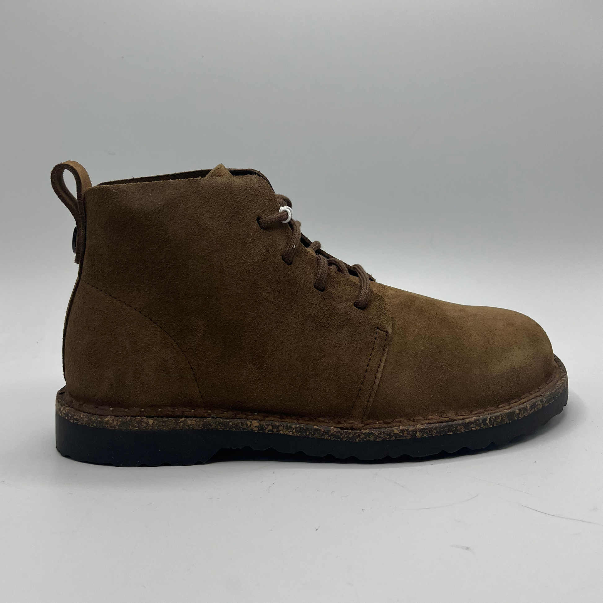 Brown suede boot on a white background